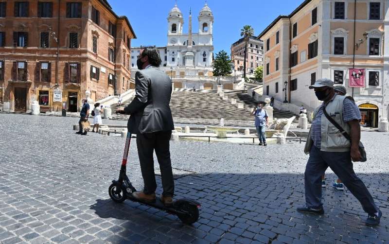 A rider passes the Spanish Steps in Rome, where a project is underway to clamp down on e-scooter use in the city